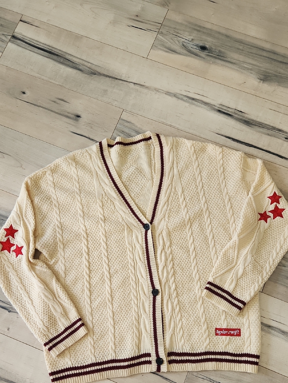 Taylor Swift Cream Cable-Knit Cardigan with Burgundy Trim and Red Star Accents
